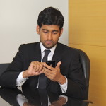Business man checking mobile phone
