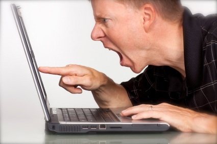 Angry man yelling at laptop